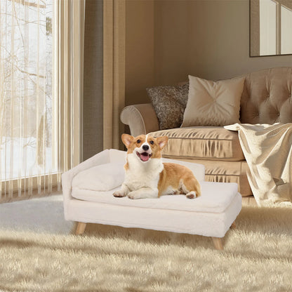 Small cream dog resting on a Nordic elevated dog bed with wooden legs and soft cushion